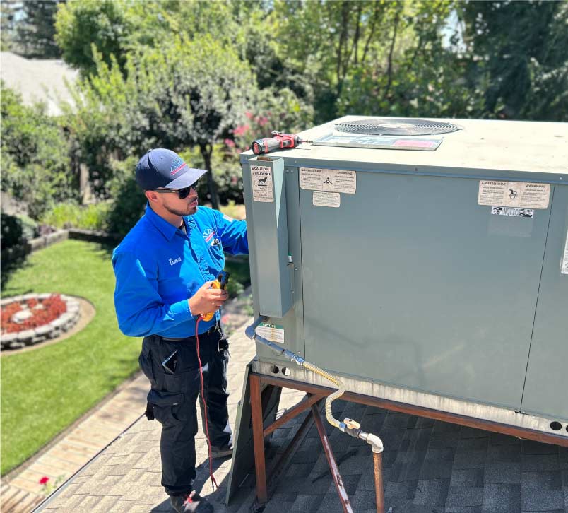 A certified Mechanical Air technician carefully connecting copper refrigerant lines to a new residential AC unit, ensuring a precise and leak-free installation.