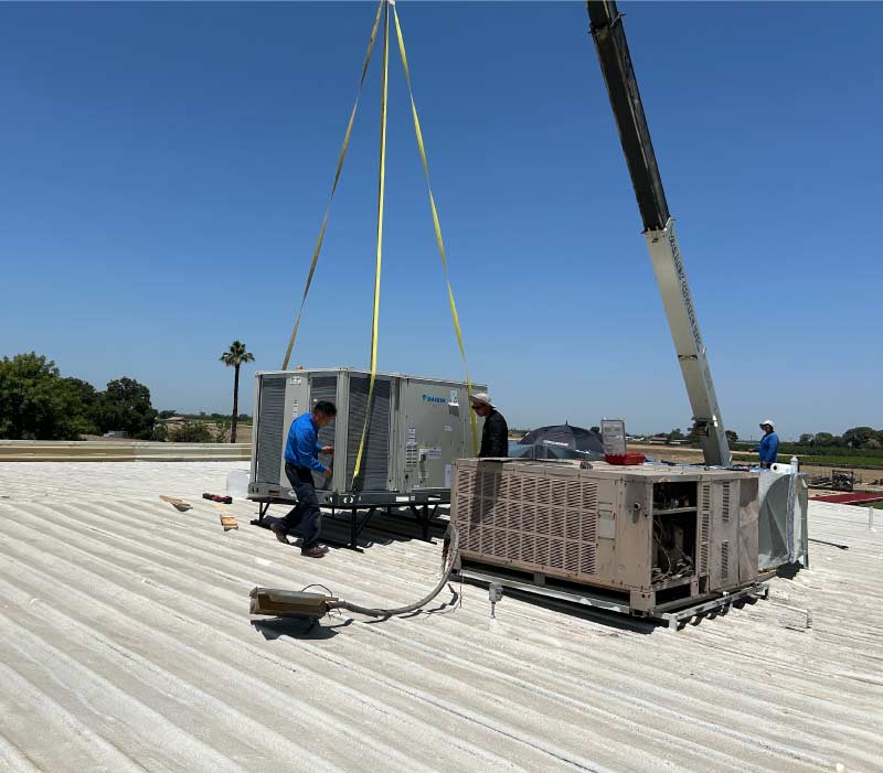 New, energy-efficient air conditioning unit being installed by a certified technician for commercial AC service.