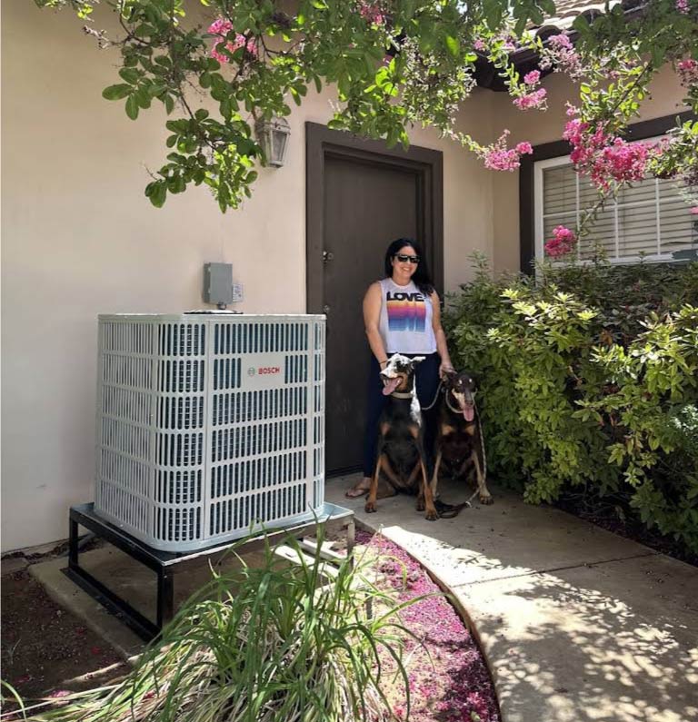 A happy Fresno homeowner enjoying a cool and comfortable weather after a professional AC service.
