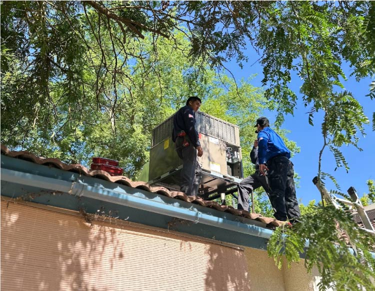 The Mechanical Air team expertly hoisting a new, high-efficiency AC condenser unit into place outside a Fresno home, explaining how much is a new ac unit