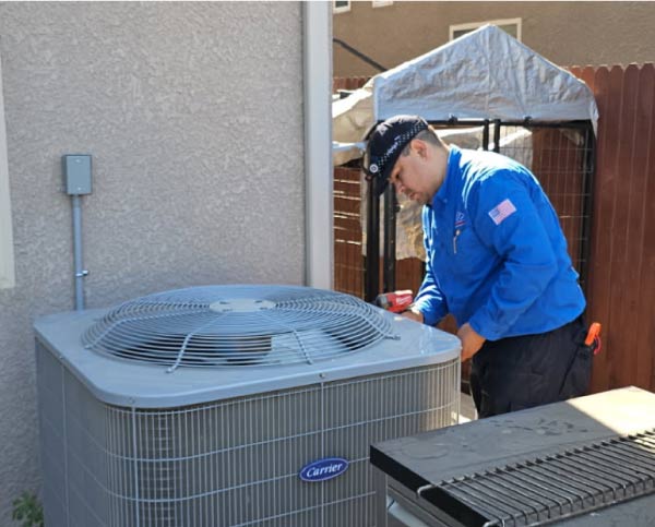 ac professional company successfully installing an air conditioning in the exterior of a residential home