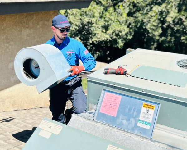 professional technician from mechanical air hvac master, installing an ac unit in the roof of a residential home in visalia, ca