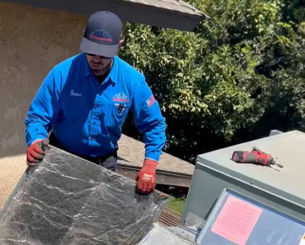 ac professional doing ac maintenance to residential property in fresno, ca