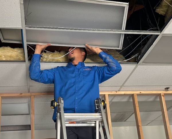 mechanical air crew performing ductwork for professional hvac service