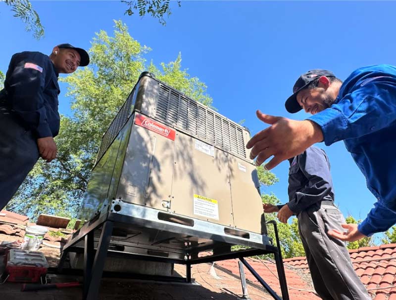 happy-hvac-team happy and Skilled team after installing succesfully a air conditioning on the roof of a residential home