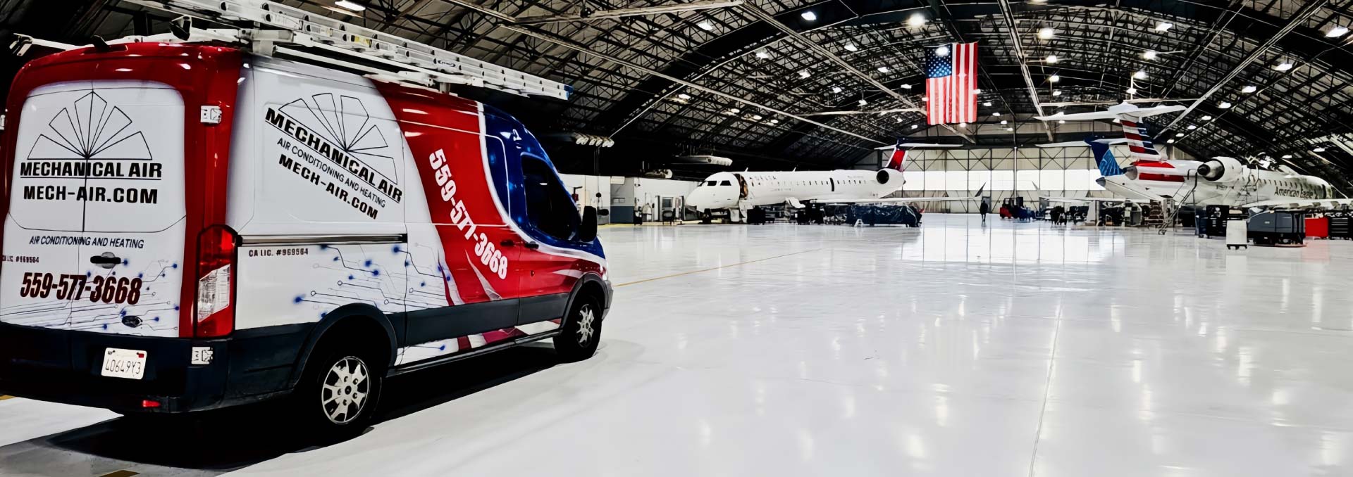 Mechanical Air service van with company branding and phone number 559-577-3668 parked inside a large professional aircraft hangar, highlighting expert commercial HVAC services.