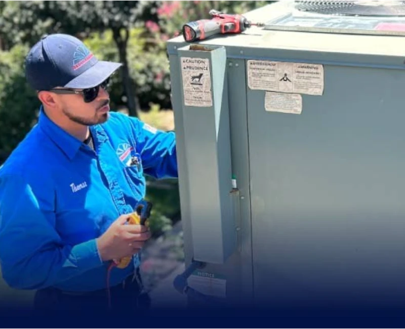 Mechanical Air HVAC technician Thomas holding a multimeter while inspecting an outdoor AC unit during a cooling diagnostic and repair service